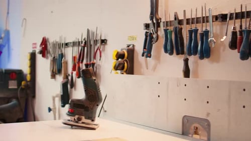 Electric Router Used for Cutting Wood in Carpentry Studio Panning Shot