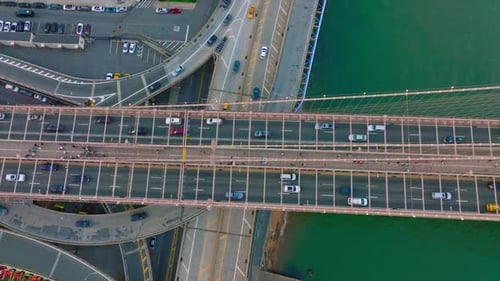 Busy traffic of big city. Multiple cars running through the roads and bridges at daytime.