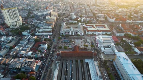 Aerial view of Jakarta Kota Train Station with Jakarta cityscape background.