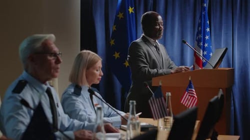 Man Giving Presentation at Podium in Formal Setting