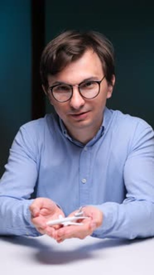 Man Holding a Toy Airplane