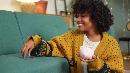 Saving Money Investment for Future African American Girl Holding Pink Piggy Bank and Putting Money