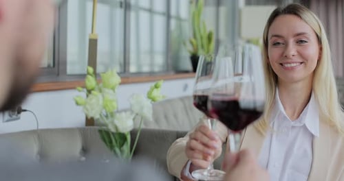 Couple Having a Dinner Clinking Glasses of Wine at a Restaurant People Enjoying Their Date Drinking