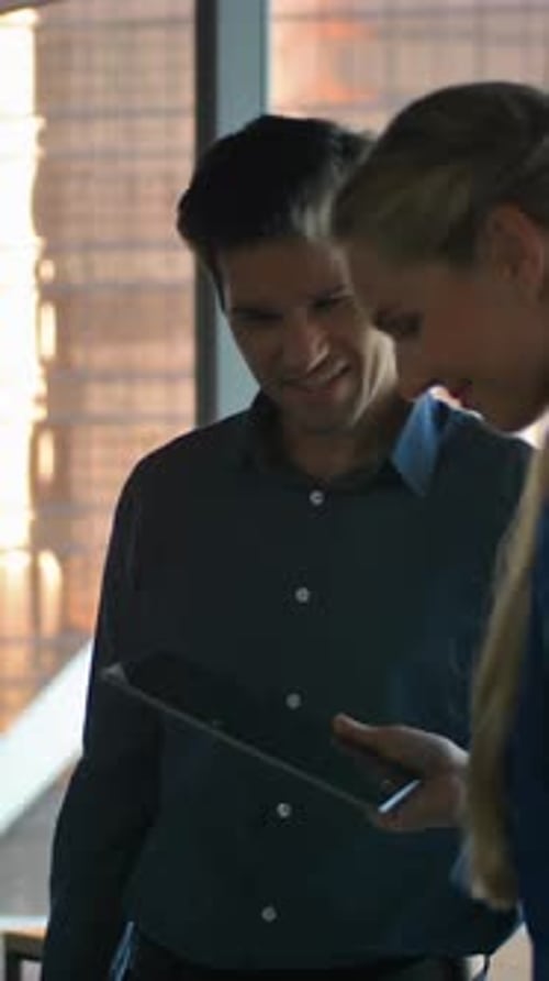 Man and Woman Use Tablet in Modern Office