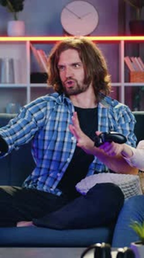 Excited man playing video games with woman