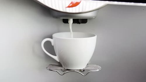 Coffee Machine Filling White Mug with Liquid