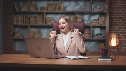 Excited Woman Video Conferencing with Laptop Indoors