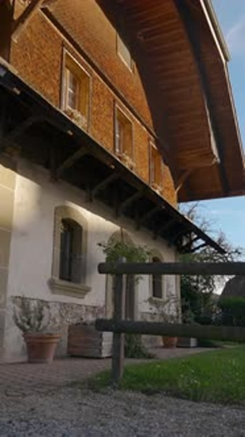 Vertical of Green Lawn in Yard of Large Twostorey Rural Cottage House