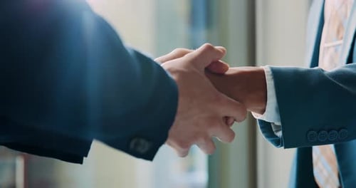 Men Shake Hands in Business Agreement