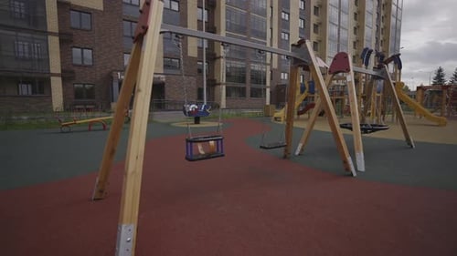 Swings on Empty Playground for Children Near Residential