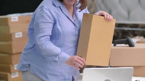 Woman Preparing Packages in Office