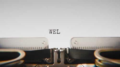 Old mechanical typewriter typing Welfare in a close-up view.