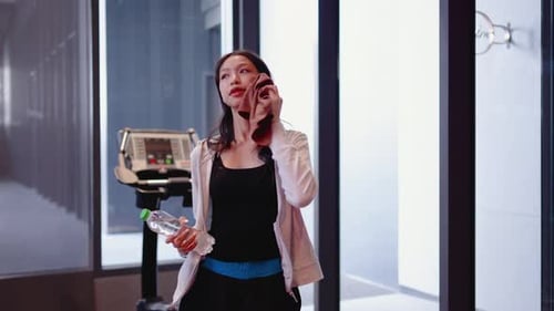 Athletic Woman Wiping Sweat and Drinking Water