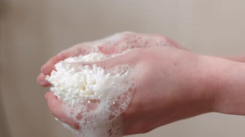 Puff Soft Ball Sponge With Foamy Soap Bubbles. Close-up Shot