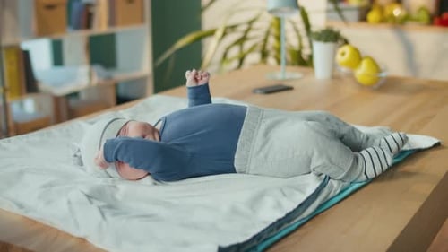 Sweet Infant Lying on Blanket on Table