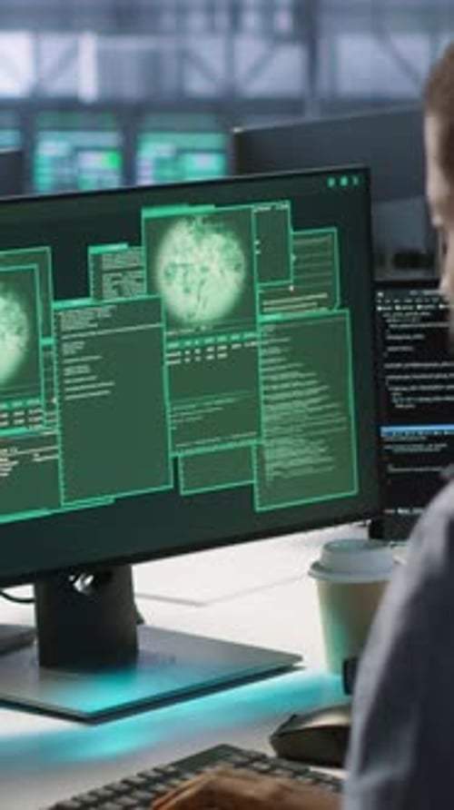 Vertical Video Cybersecurity Team Monitoring Security Incidents Affecting Data Center