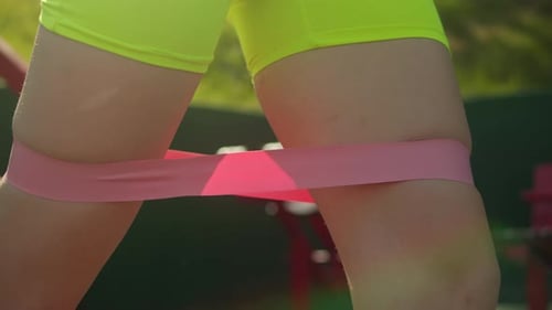 Woman Using Resistance Band During Leg Workout