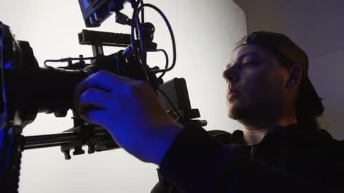 Videographer Getting his Camera Ready for Shoot in Studio