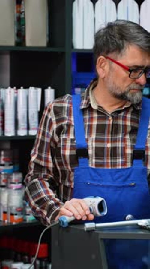 Senior Worker Scanning Auto Tool with Barcode Reader
