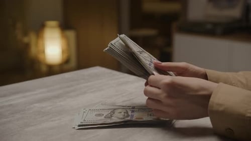 Hands Counting United States One Hundred Dollar Bills