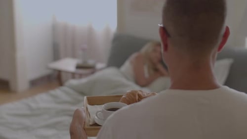Husband Bringing Breakfast to His Wifes Bed