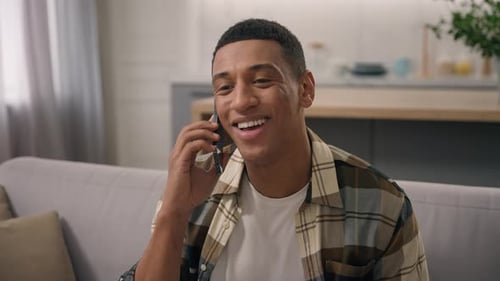 Young Adult Talking on Phone in Living Room
