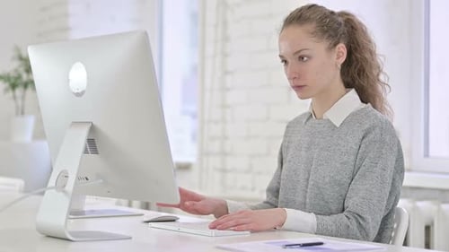 Serious Young Businessman doing Paperwork in Office