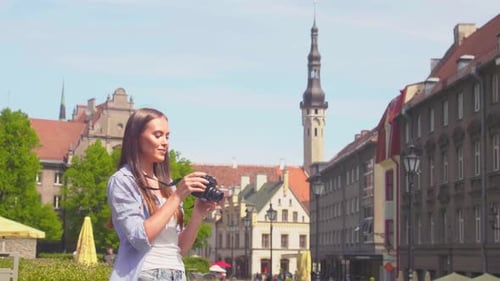 Attractive Young Girl Traveling and Exploring Beautiful Old Town Tourist with a Retro Camera