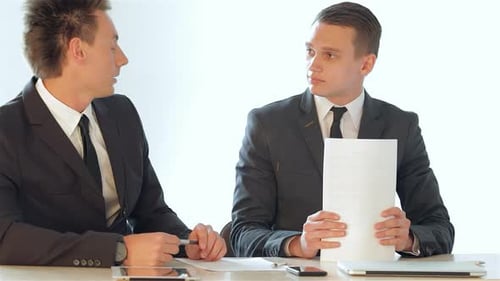 Businessmen Conclude Their Discussion As One Confidently Picks Up His Document