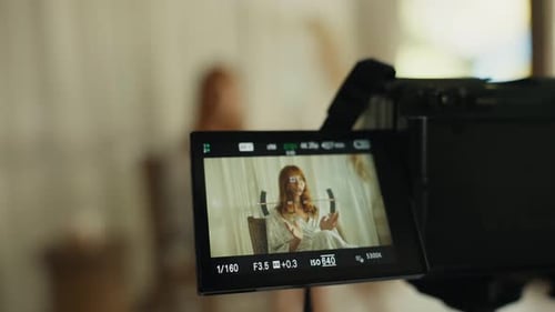 Woman On Camera Display in a Studio