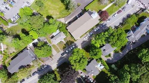 Aerial top down view of people marching on roads during a parade show.