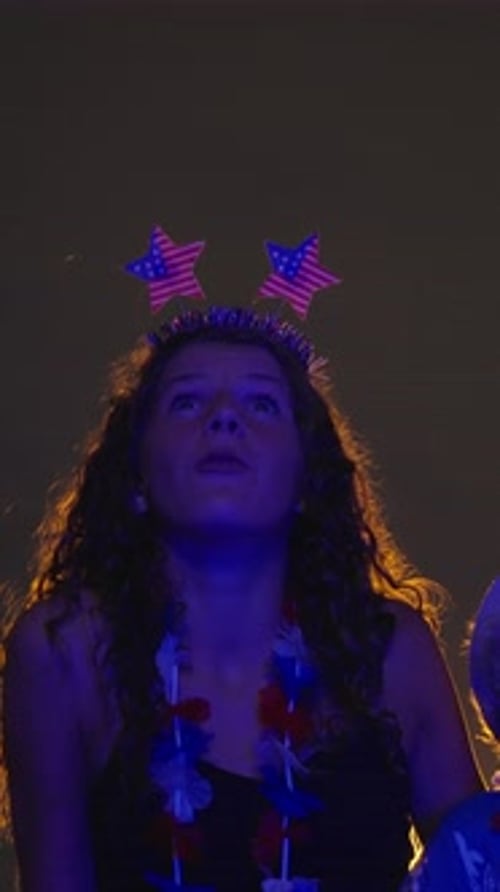 Young Girl Wearing Star Headband Enjoying Nighttime Fireworks