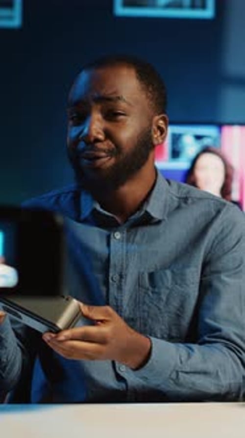 Young Adult Talking about Technology in Blue Light