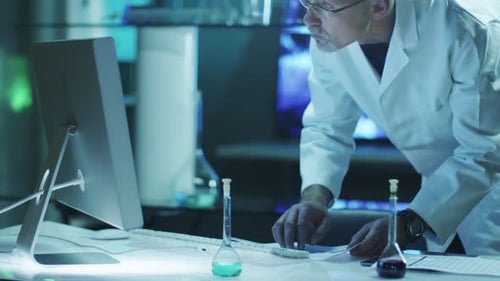 Scientist Types at Computer in Laboratory