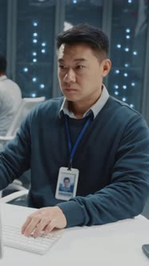 Chinese Asian Millennial Adult Office Manager Programming Software Servers in Data Center