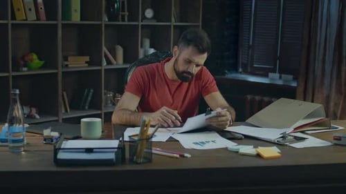 Young Businessman Working in Cozy Office. Paperwork at Creative Office. Man Putting