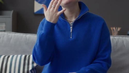 Adult Signing Indoors In a Blue Sweater