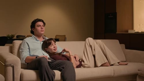 Affectionate Couple Relaxing Together on Couch at Home