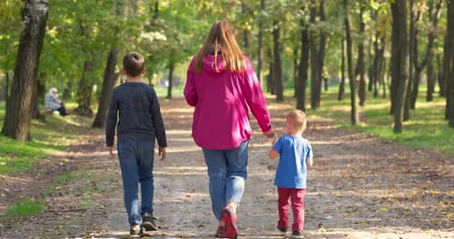 Happy Family Enjoying Walk Outdoors in the Park