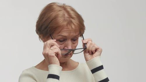Woman Puts on Her Eye Glasses