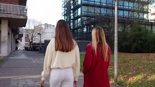 Two Women Friends Walking and Talking After Shopping in Slow Motion