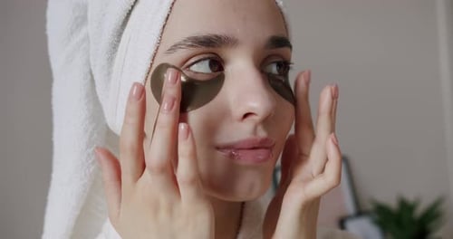 Woman Applies Eye Patches For Beauty Treatment