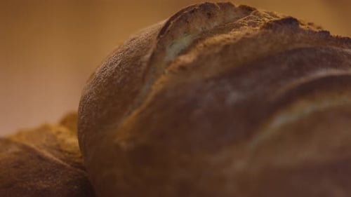 Close up of the crust of a golden bun, macro slow motion shot