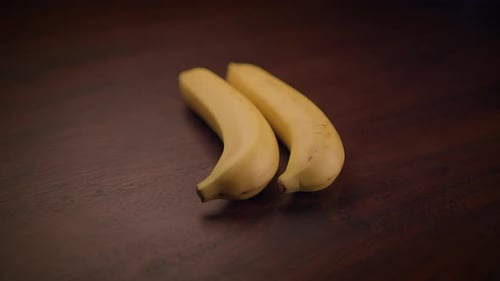 A Beautiful Arrangement of Fresh Ripe Bananas Showcased Prominently on a Rustic Wooden Surface