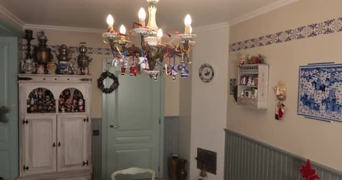 Woman Arranges Floral Centerpiece on Table at Home