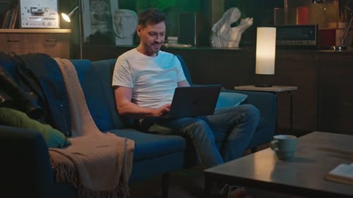 Adult Working on Laptop in Living Room