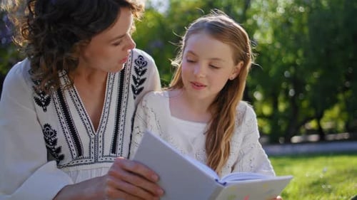 Happy Family Reading Book Gathering in Cozy Garden Closeup Woman Girl Resting