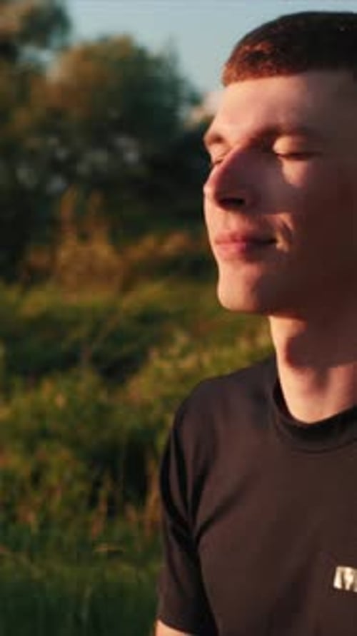 Young Man Meditating Outside in Golden Light