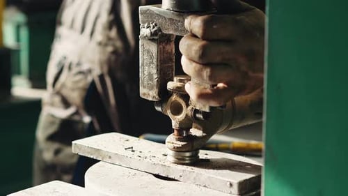 Close-up shot of mechanic presses out the cross joint of the driveshaft in a specialized auto