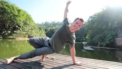 Young fitness man doing yoga exercise outdoors, balance and equilibrium